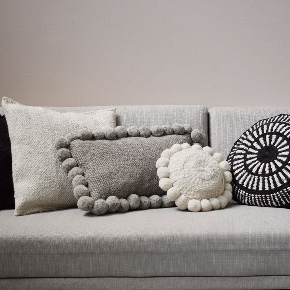 ambiance-2-mini-coussin-rond-pompons-blanc-finca-home Coussin en laine blanc et noir Finca Home - Ambiance 3